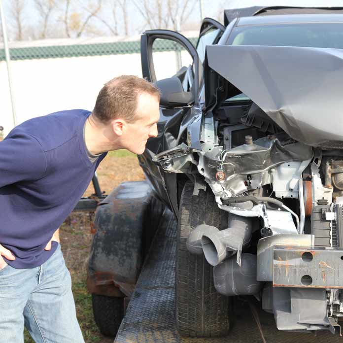 Lawyer Inspects Car after Crash