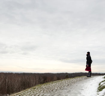 young woman alone on road contemplating