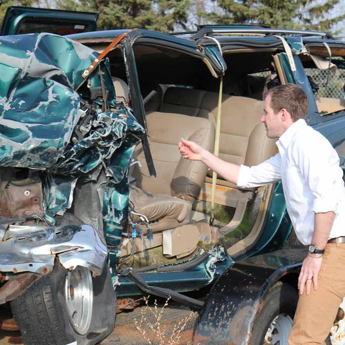 Vehicle Crash Injury Lawyer Inspecting a Car