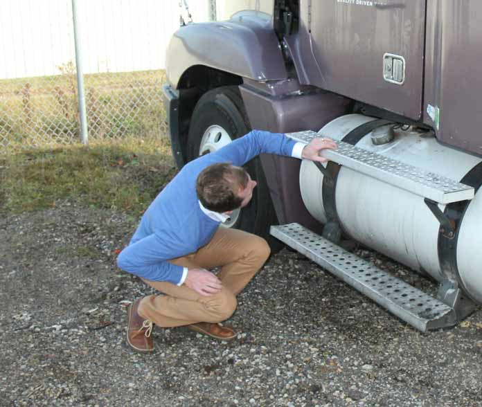 Attorney Inspecting Under Truck