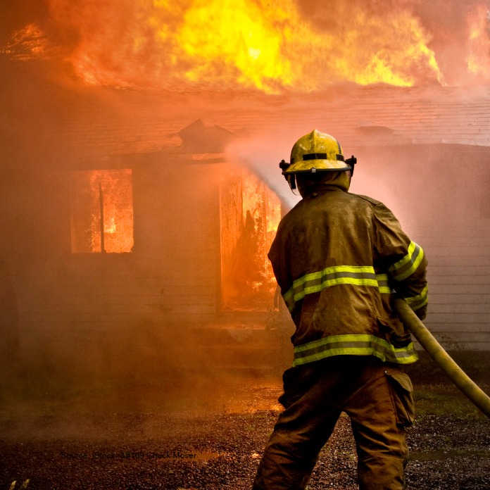 Firefighter battles house fire