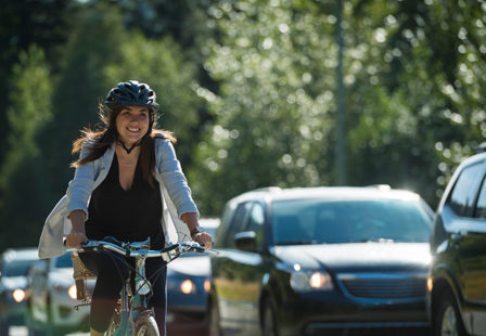 woman riding her bike with traffic