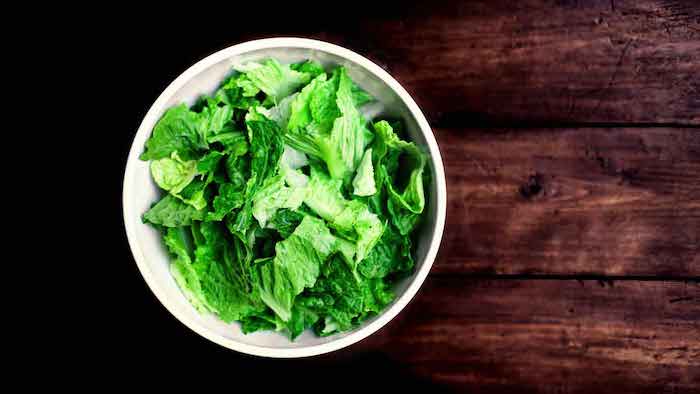 E.coli lawyer -romaine lettuce in a white bowl on a table