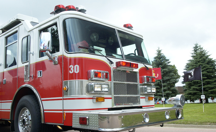 Explosion lawyer - Fire truck with Marine Corps flag and POW MIA flag in background