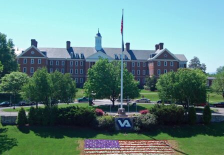 Salem VA Medical Center exterior with landscaped grounds and an American flag. US Government Produced Image - VA Flickr