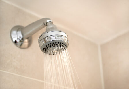 Apartment shower with running water, a potential source of Legionella exposure when bacteria are present in a building hot water system